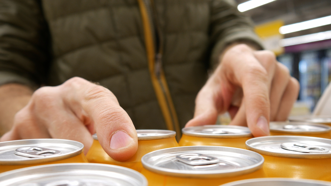 image of person sorting cans of drinks