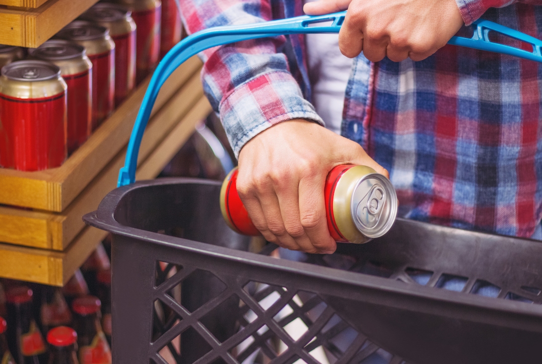 image of man holding a can of alcohol