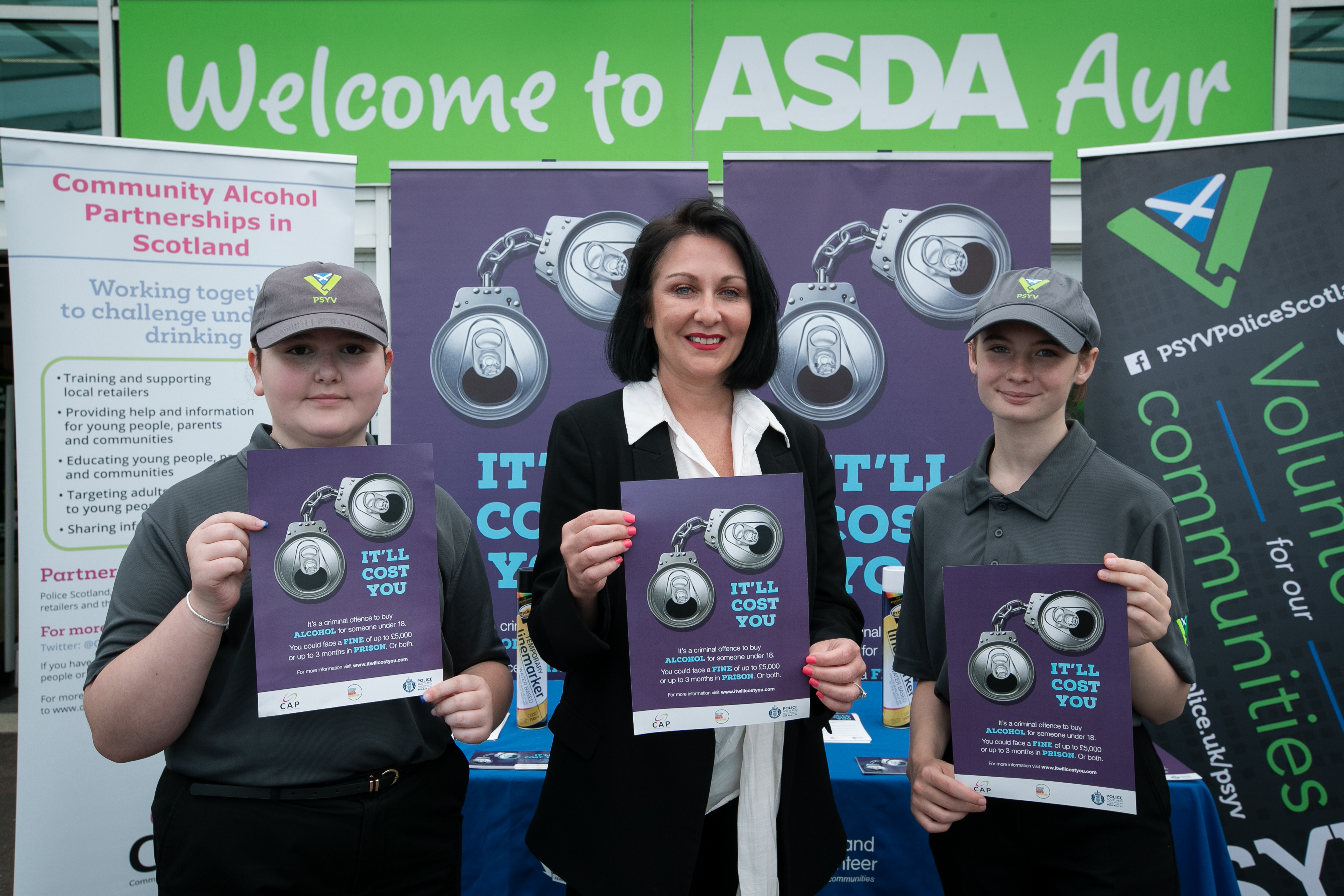 Community Safety Minister with 2 Youths from Police Scotland Youth Volunteers holding "It will Cost You" leaflets